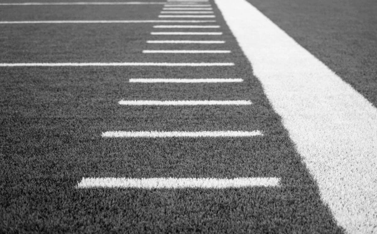 A close-up view of a football field, with the yard lines clearly visible.